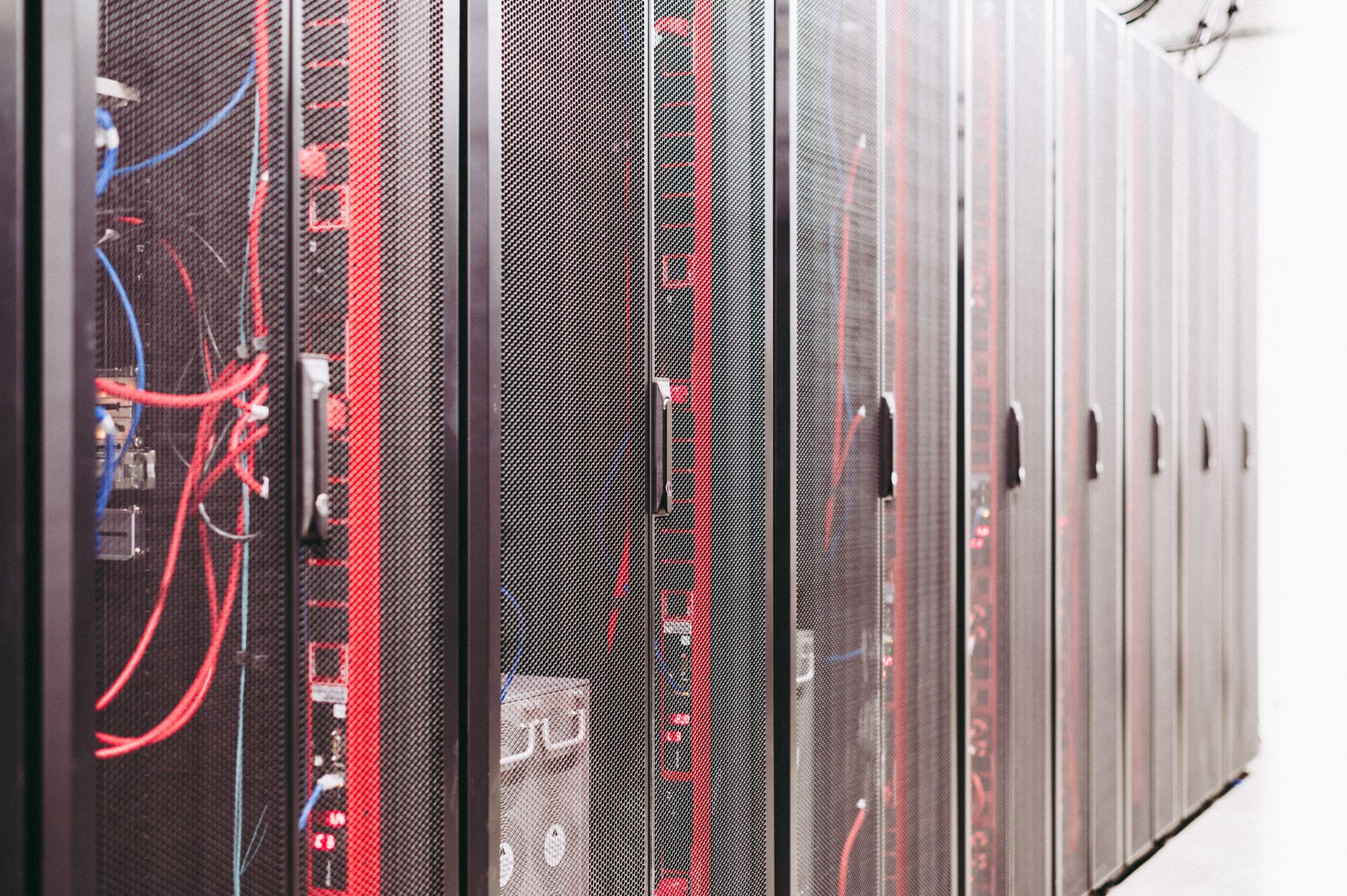 Rows of illuminated server racks inside a large data center facility