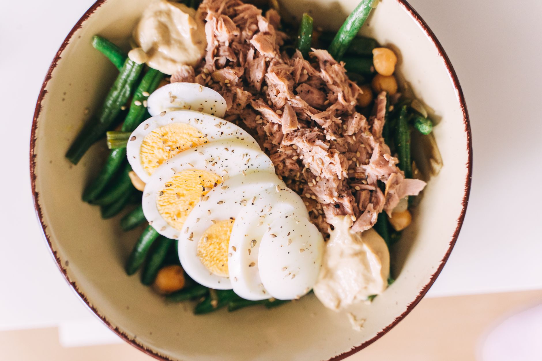 Low-carbohydrate ketogenic meal with avocado, eggs, and leafy greens on a plate