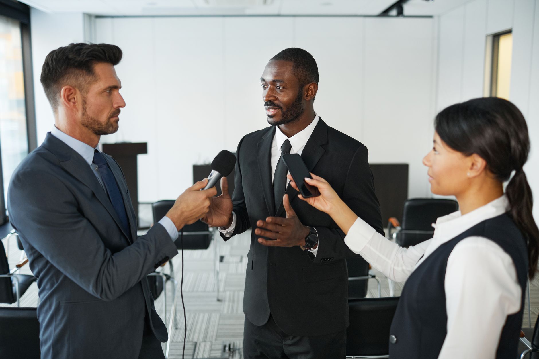 Business professionals reviewing documents in a formal meeting setting