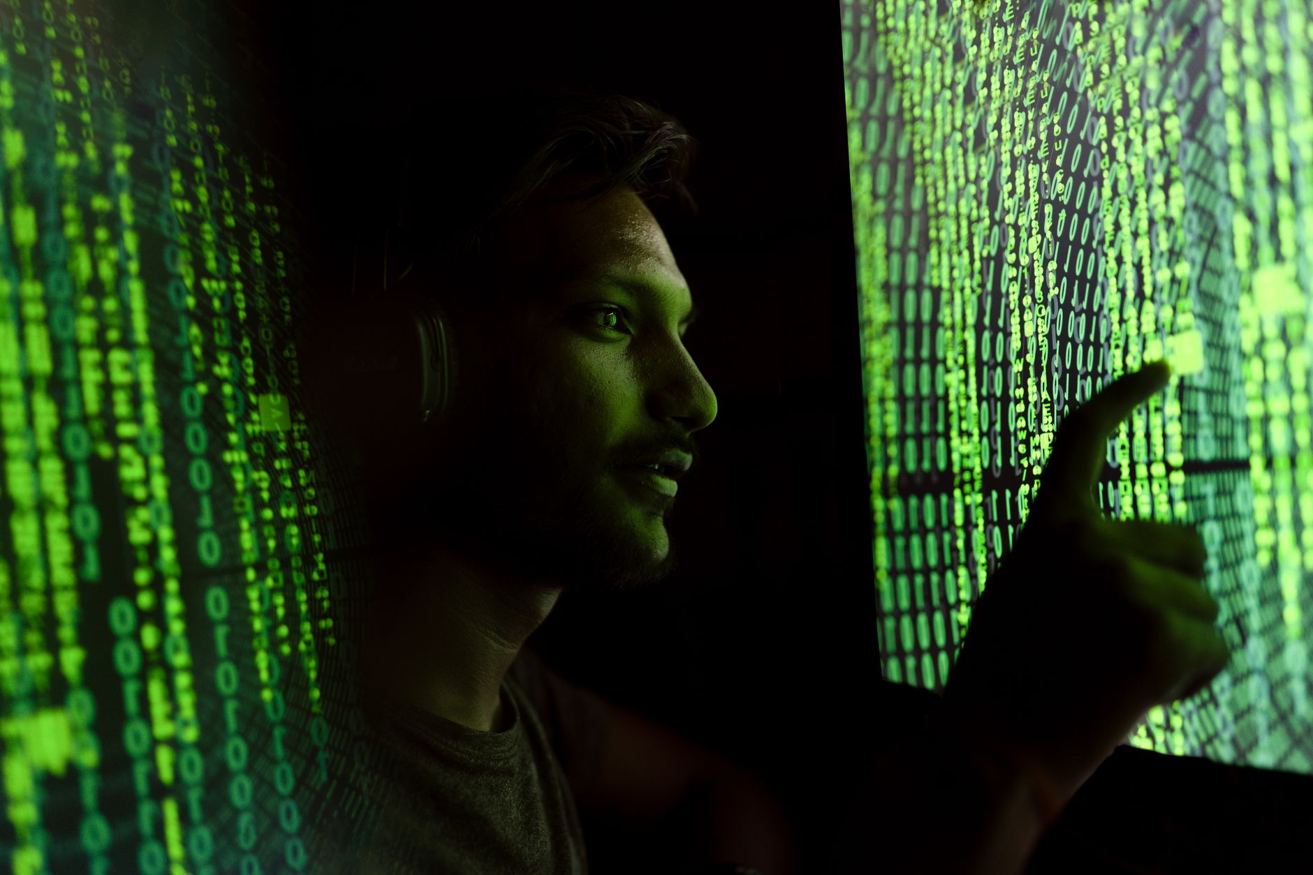 Dark room with code visible on a computer monitor