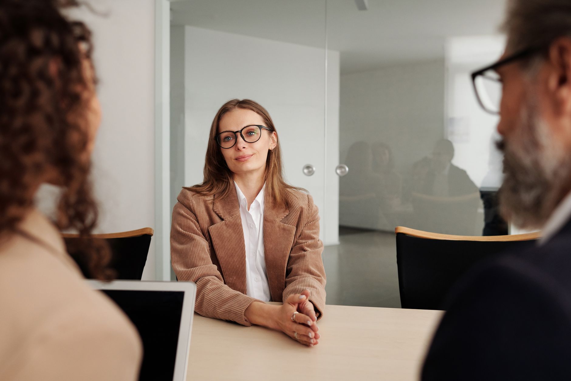 Person sitting across a desk in a formal job interview setting