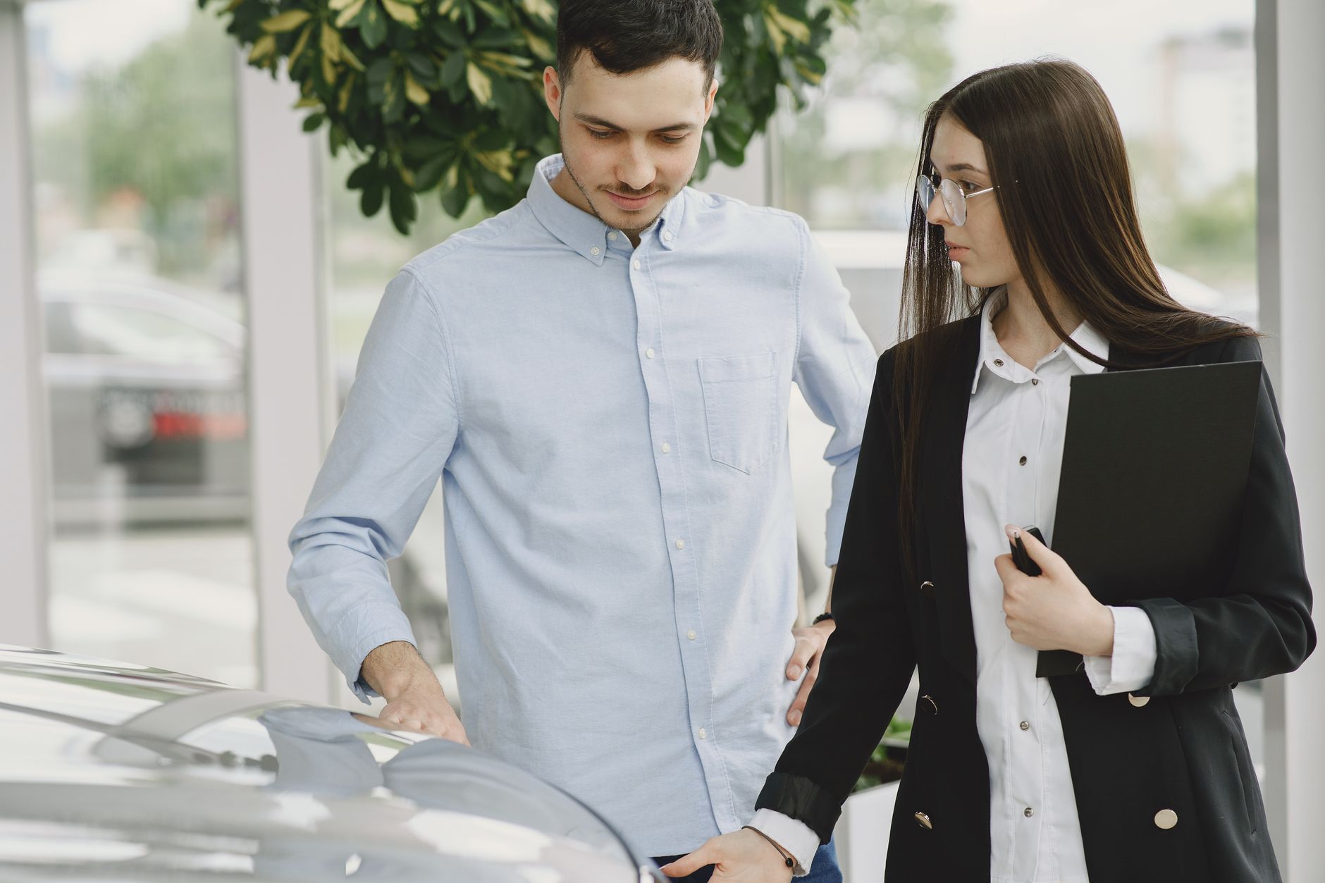 Automotive dealer reviewing business documents at a desk