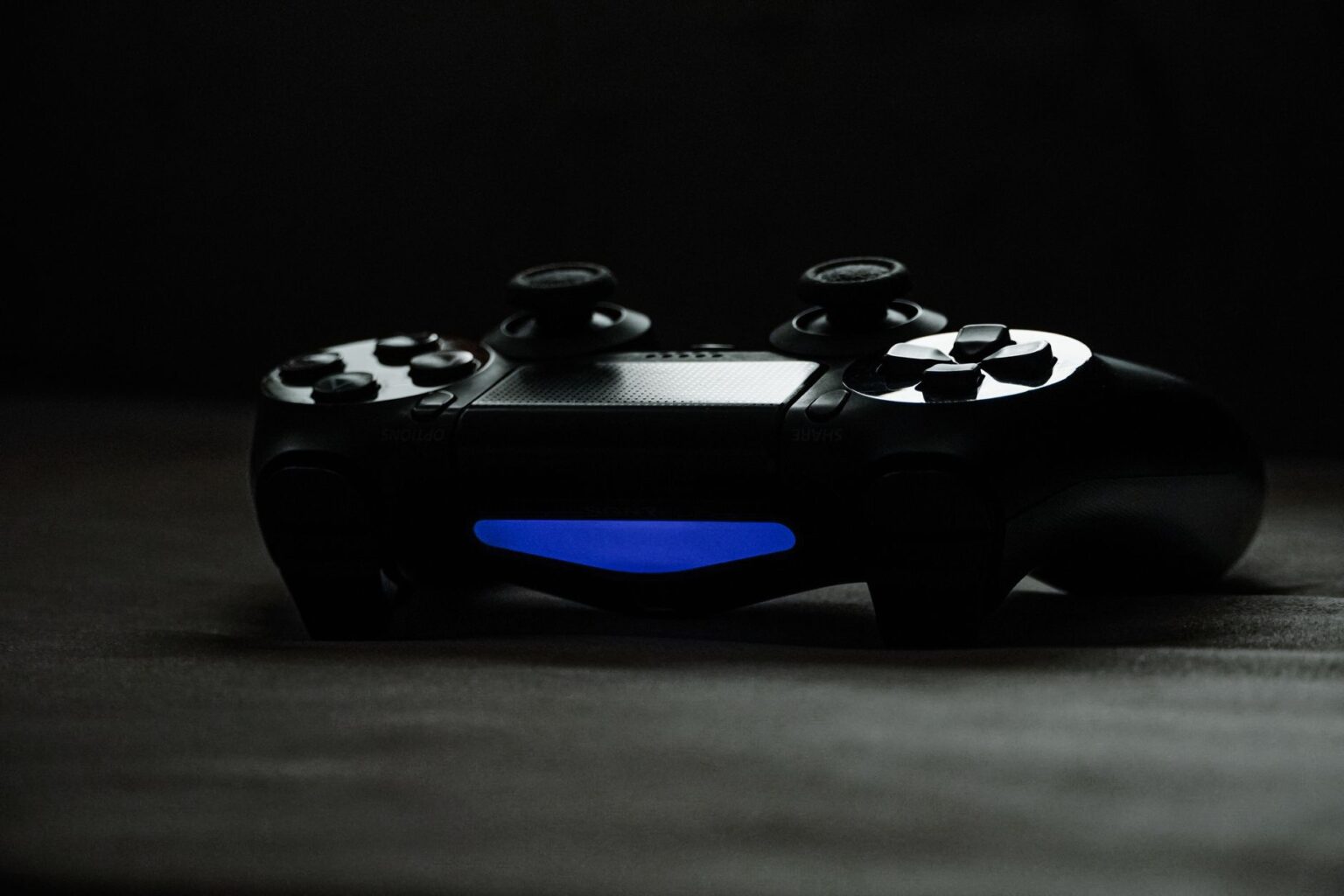 A gaming controller resting on a desk representing Overwatch hero gameplay
