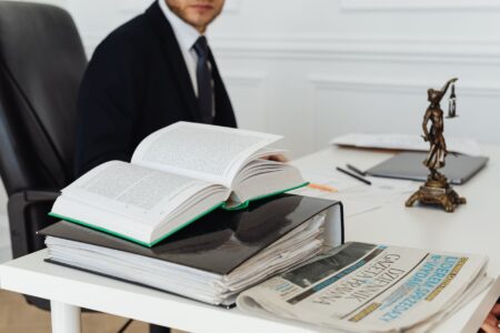 Legal documents and a gavel on a desk representing a corporate lawsuit