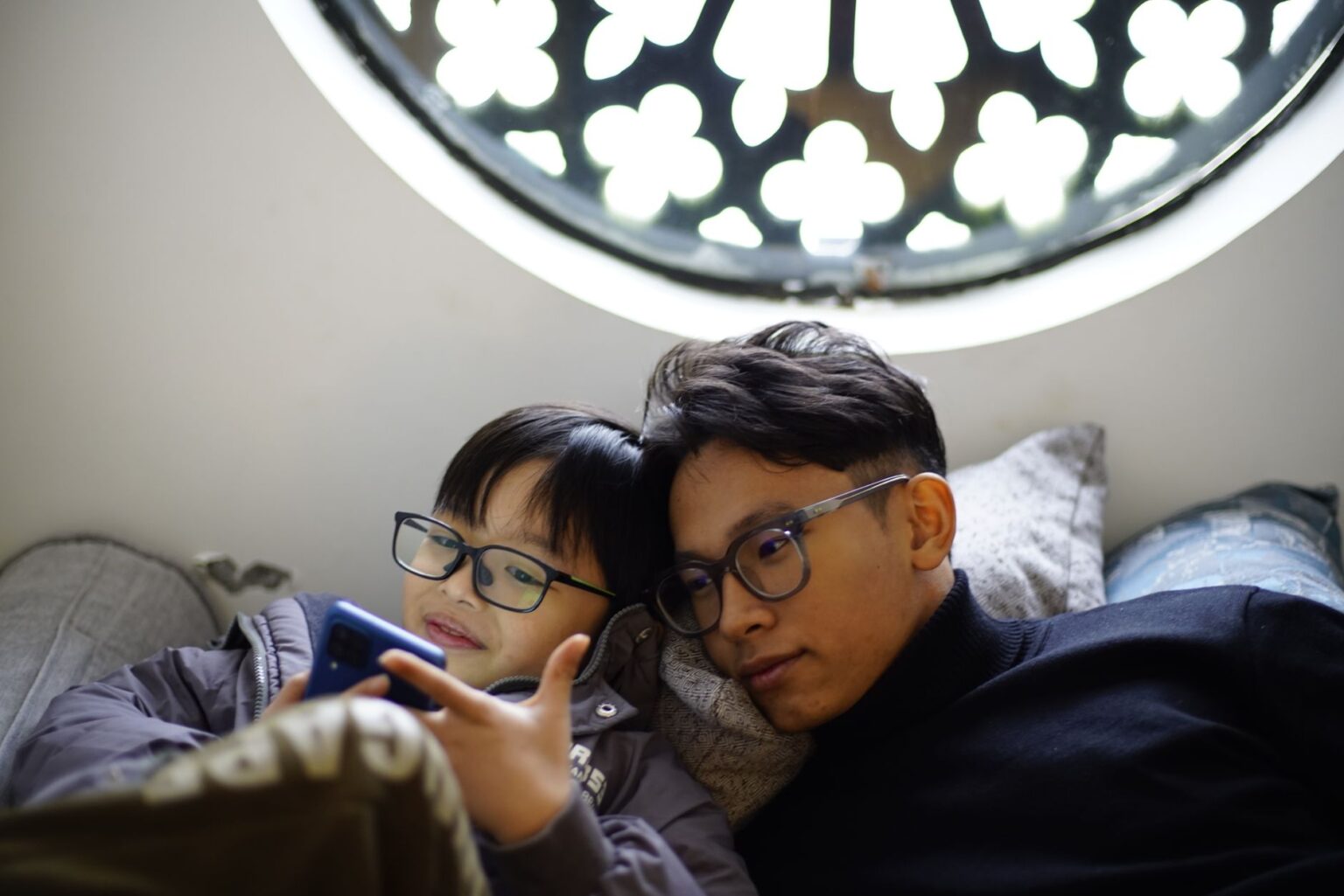 Parent and child looking at a smartphone together at home