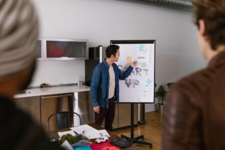 Founders presenting financial data during a startup pitch meeting with investors