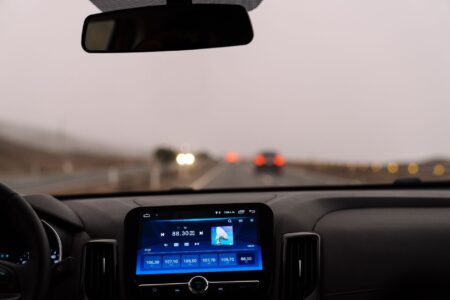 Waymo Runs at Level 4. Level 5 May Never Exist. A autonomous vehicle navigating an urban street with sensor arrays visible on roof