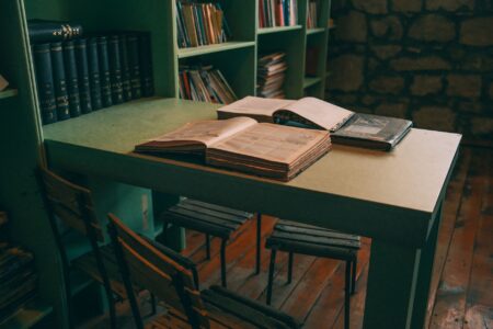 Stacks of open books in a library representing copyrighted literary works used in AI training