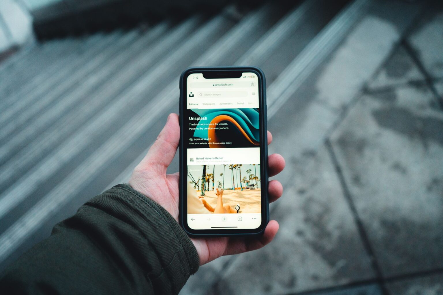 Outernet App Converts Saved Posts Into Actual Outings Person scrolling through saved posts on a smartphone screen