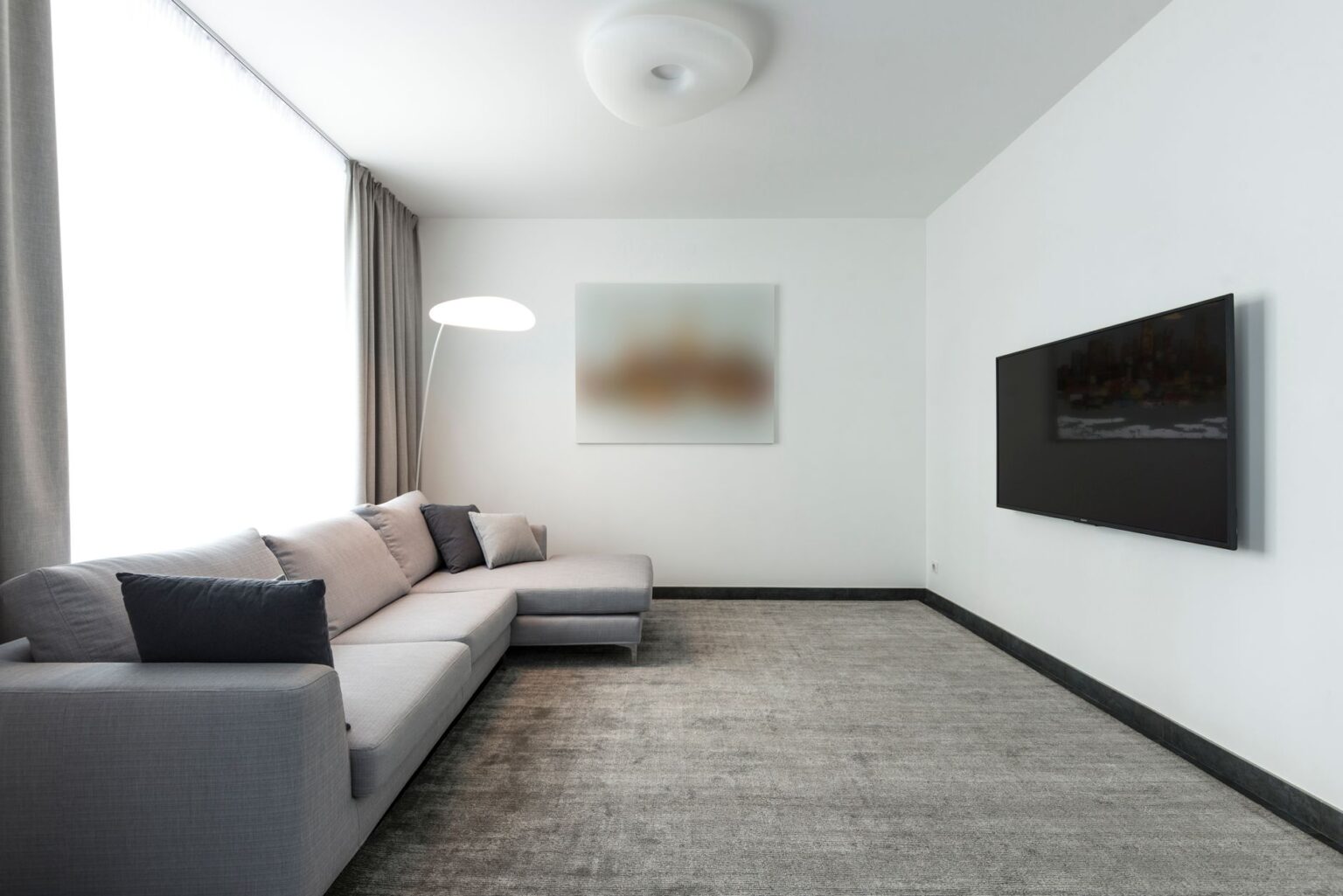 VESA Mounts Explained: What Those Numbers Actually Mean Large flat-screen TV mounted on a white living room wall