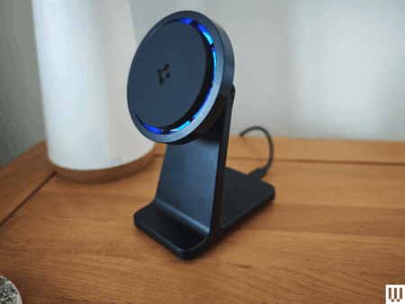 Smartphone resting on a wireless charging pad on a nightstand