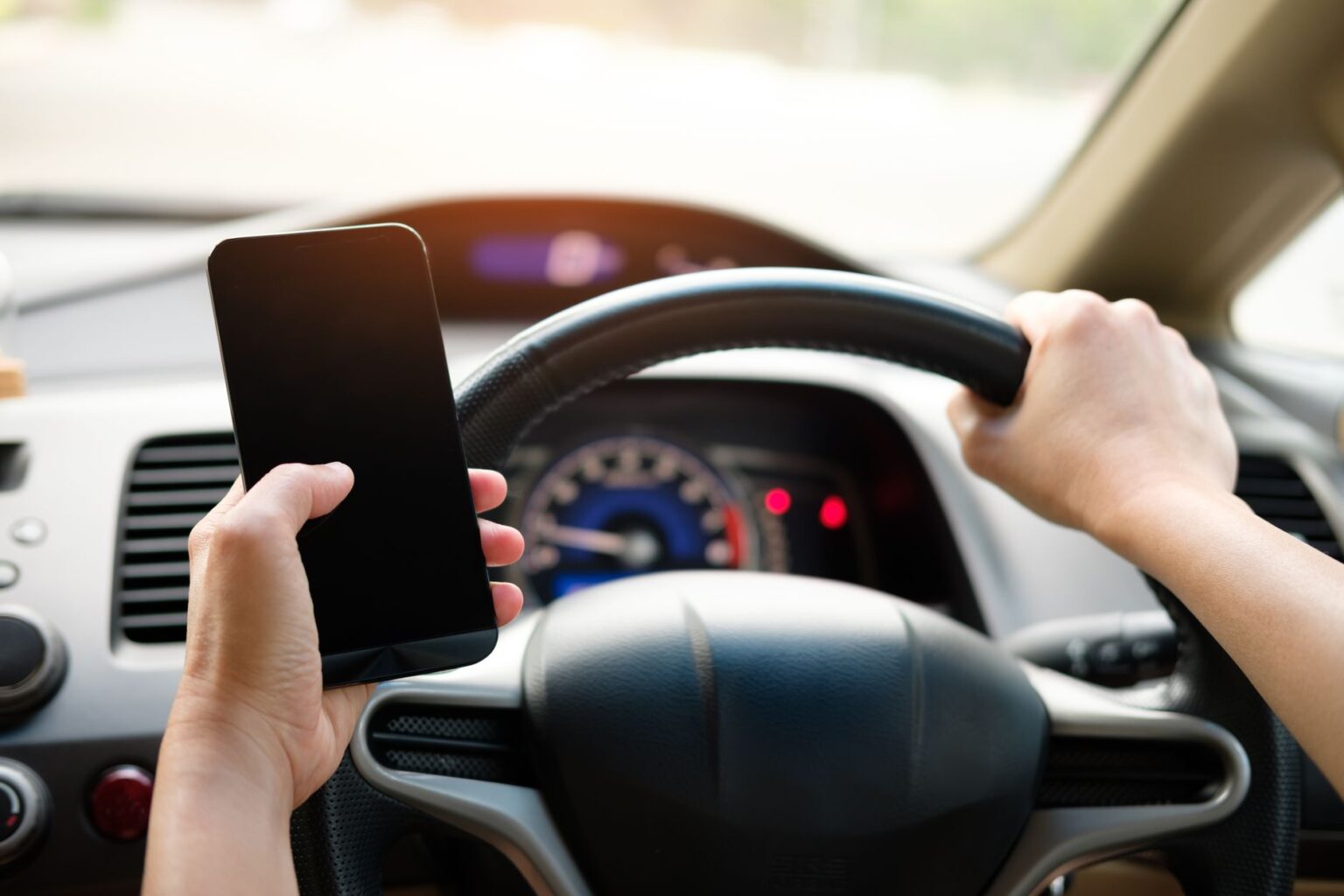 Apple and Google Face UK Criminal Liability After Missing Child Safety Deadline Person holding a smartphone with a blurred legislative building in the background