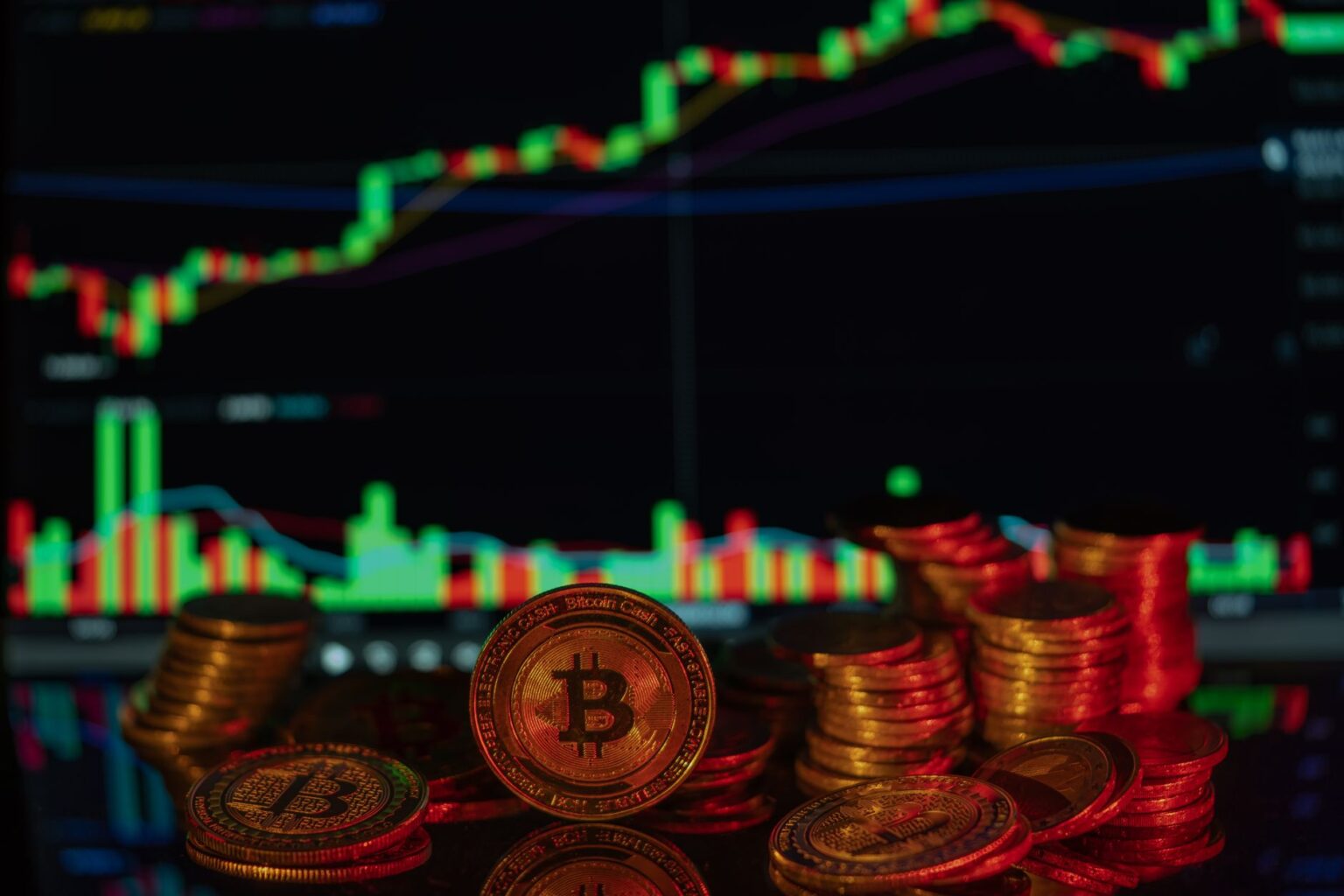 Digital cryptocurrency coins on a dark surface representing the INDXcoin fraud case