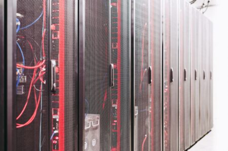 Rows of servers inside a large AI data center facility