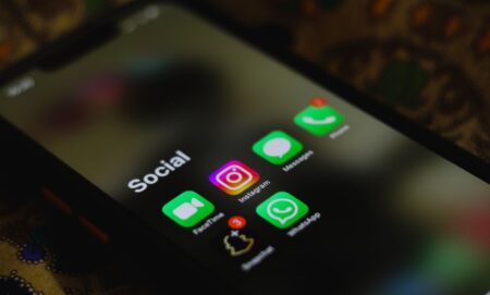 Person reviewing content on a smartphone screen representing social media moderation