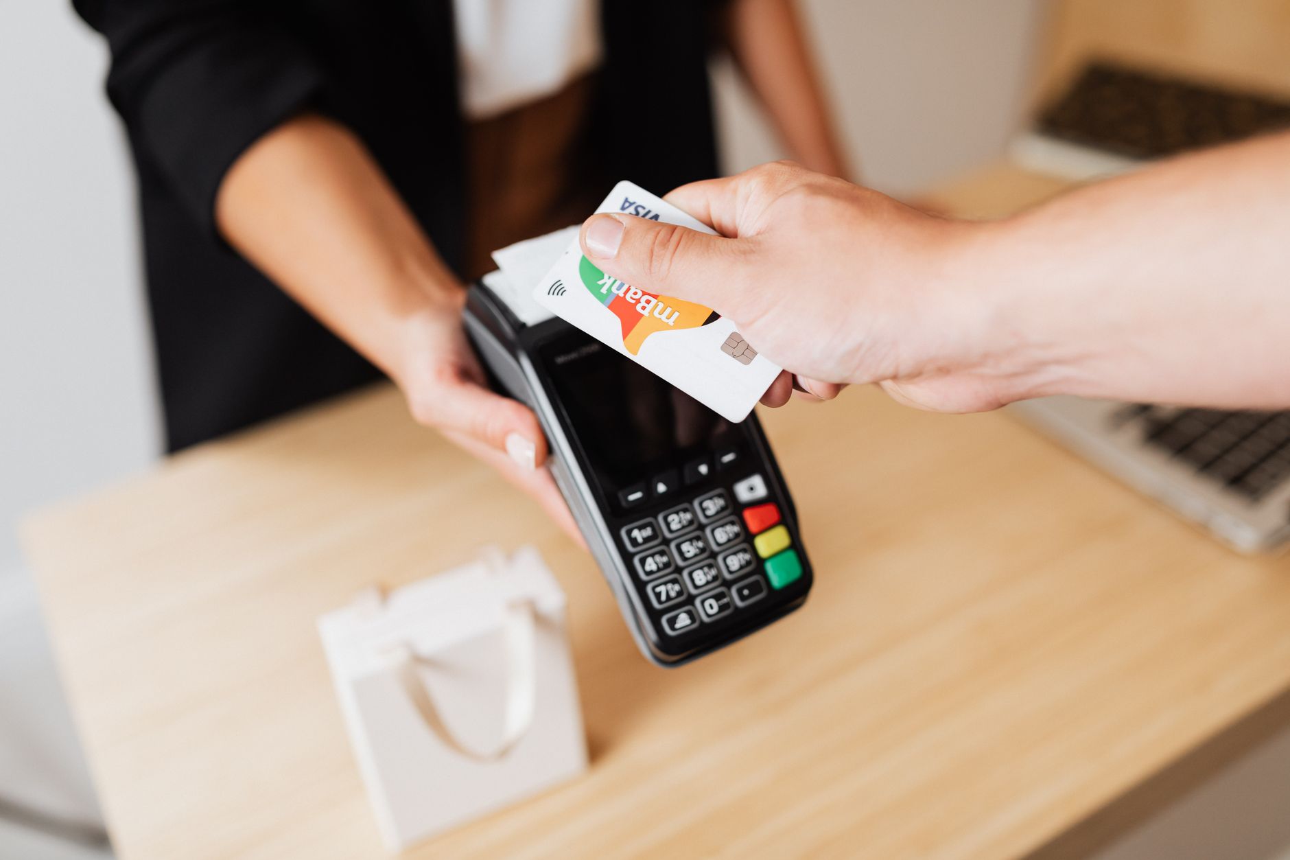 Customer paying at a modern retail checkout counter