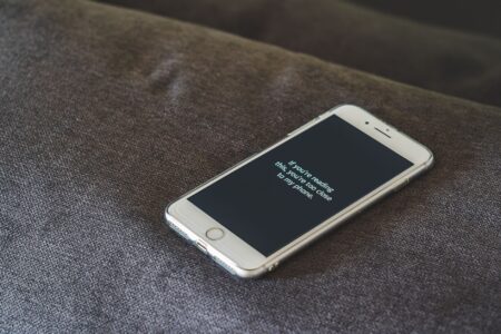 Person holding a smartphone with a privacy screen, representing mobile data concerns