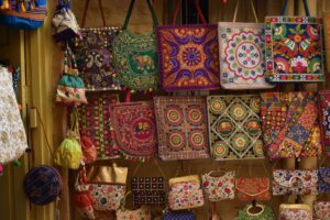 Colorful decorative charms hanging from a bag zipper