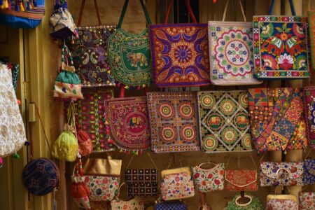 Colorful decorative charms hanging from a bag zipper