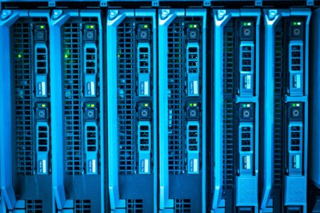 Rows of servers inside a modern data center with blue lighting