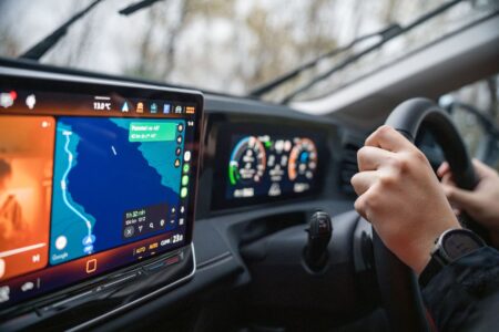 Wireless Android Auto: What You Gain, What You Give Up Driver using an Android Auto interface on a car's infotainment touchscreen
