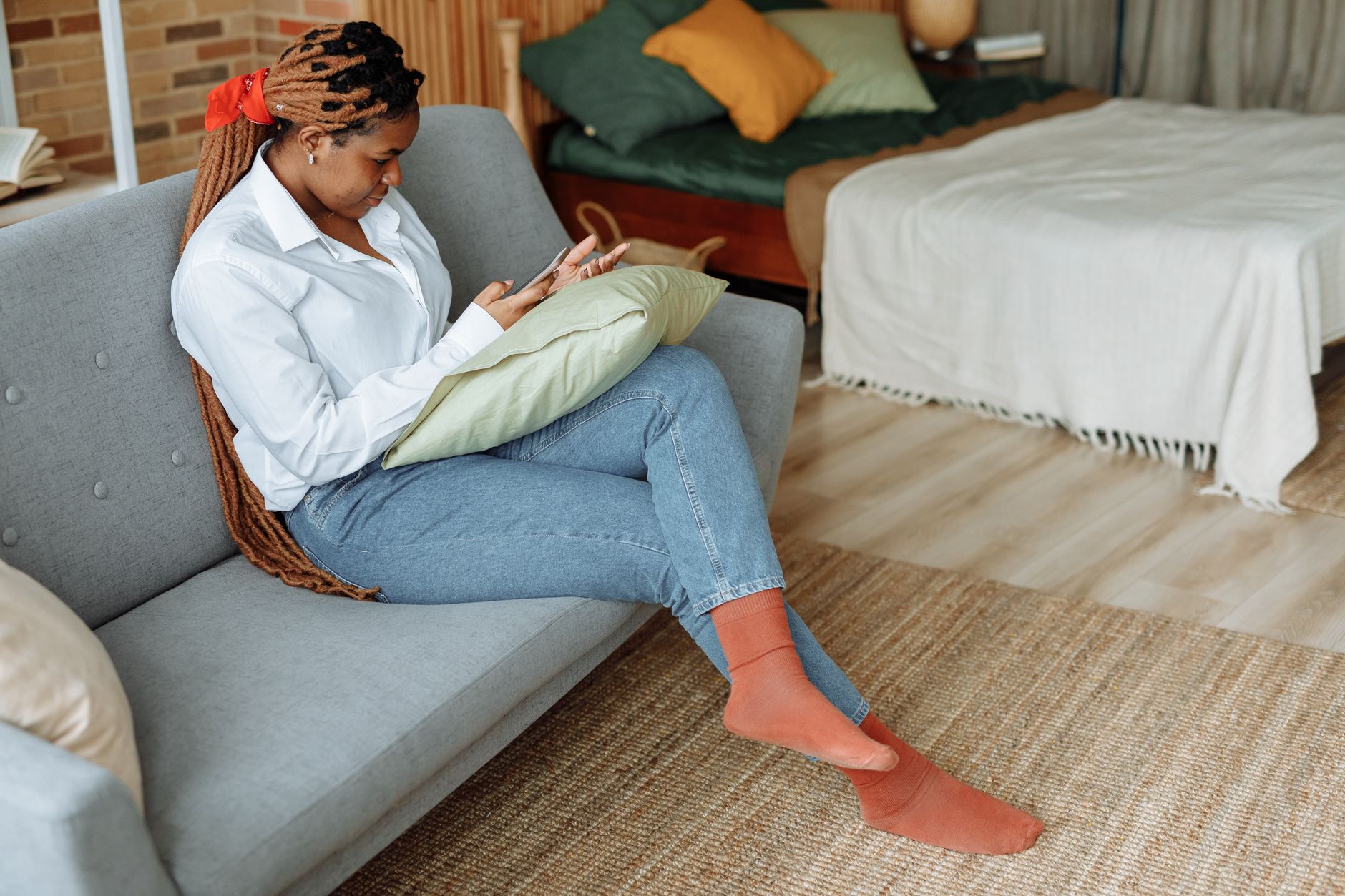 A person holding a smartphone while looking around a home interior