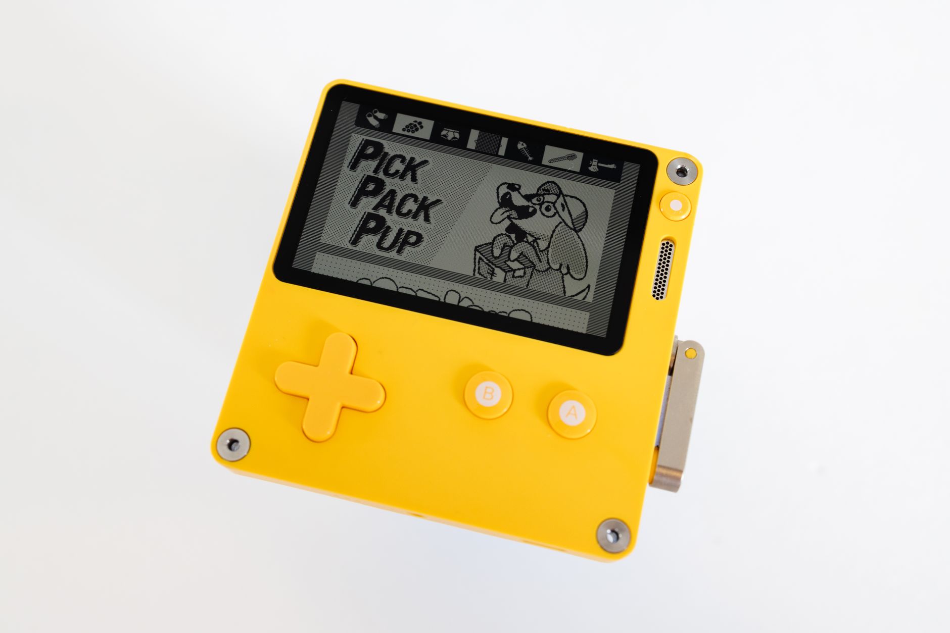 Small retro-style handheld electronic device on a flat surface