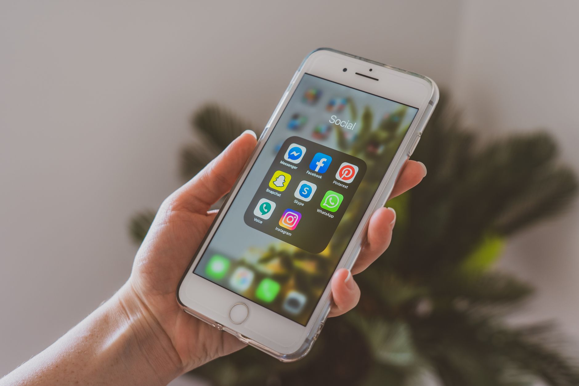 Person using social media app on smartphone representing X platform digital activity